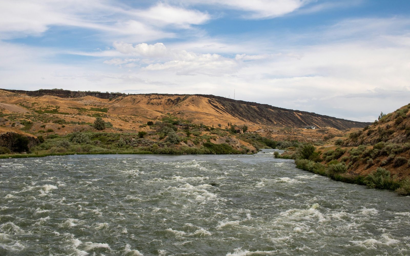 A river running through a lush green hillside